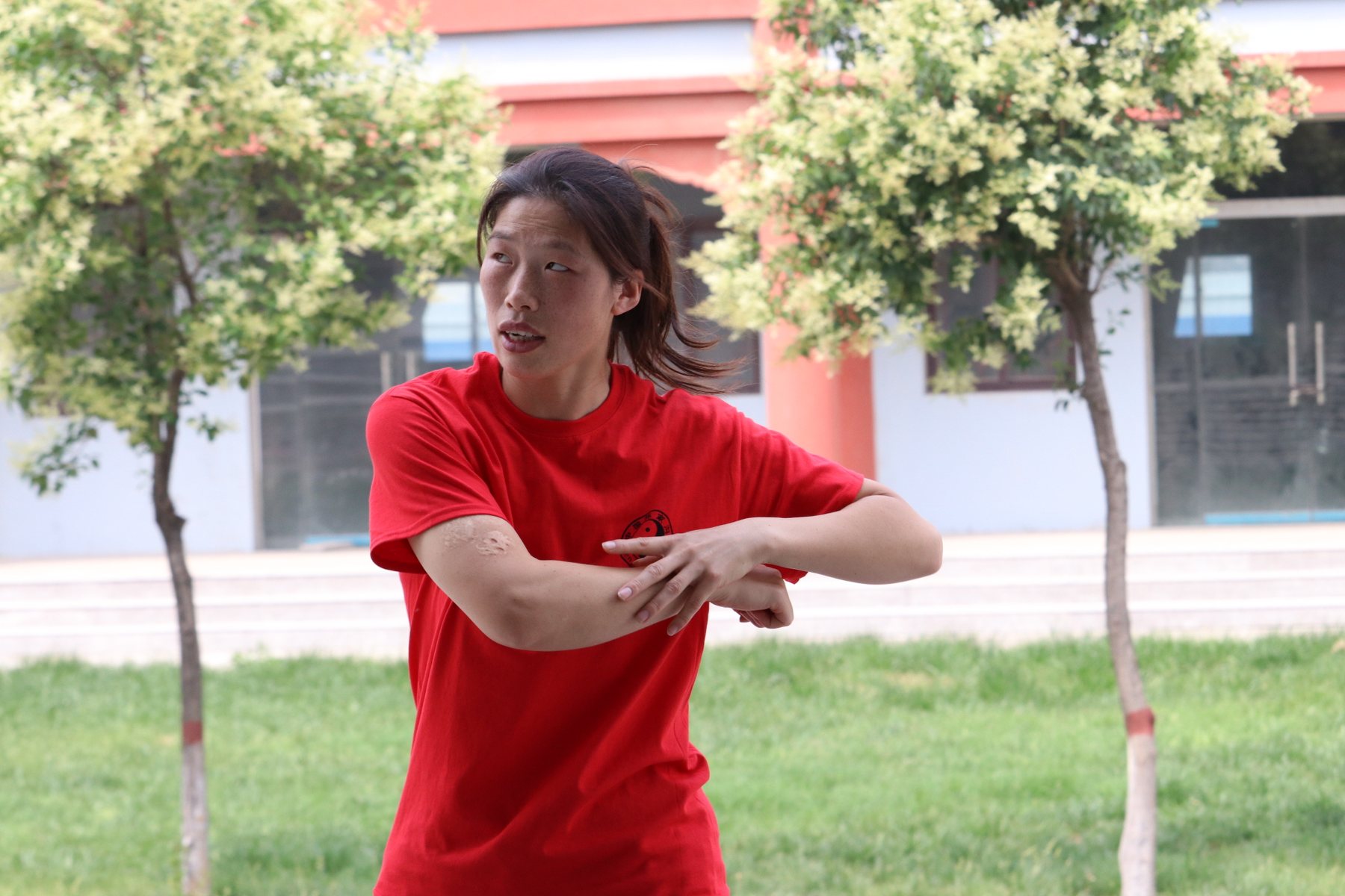 Master Chen Huixian explaining body mechanics with her hands in Chenjiagou