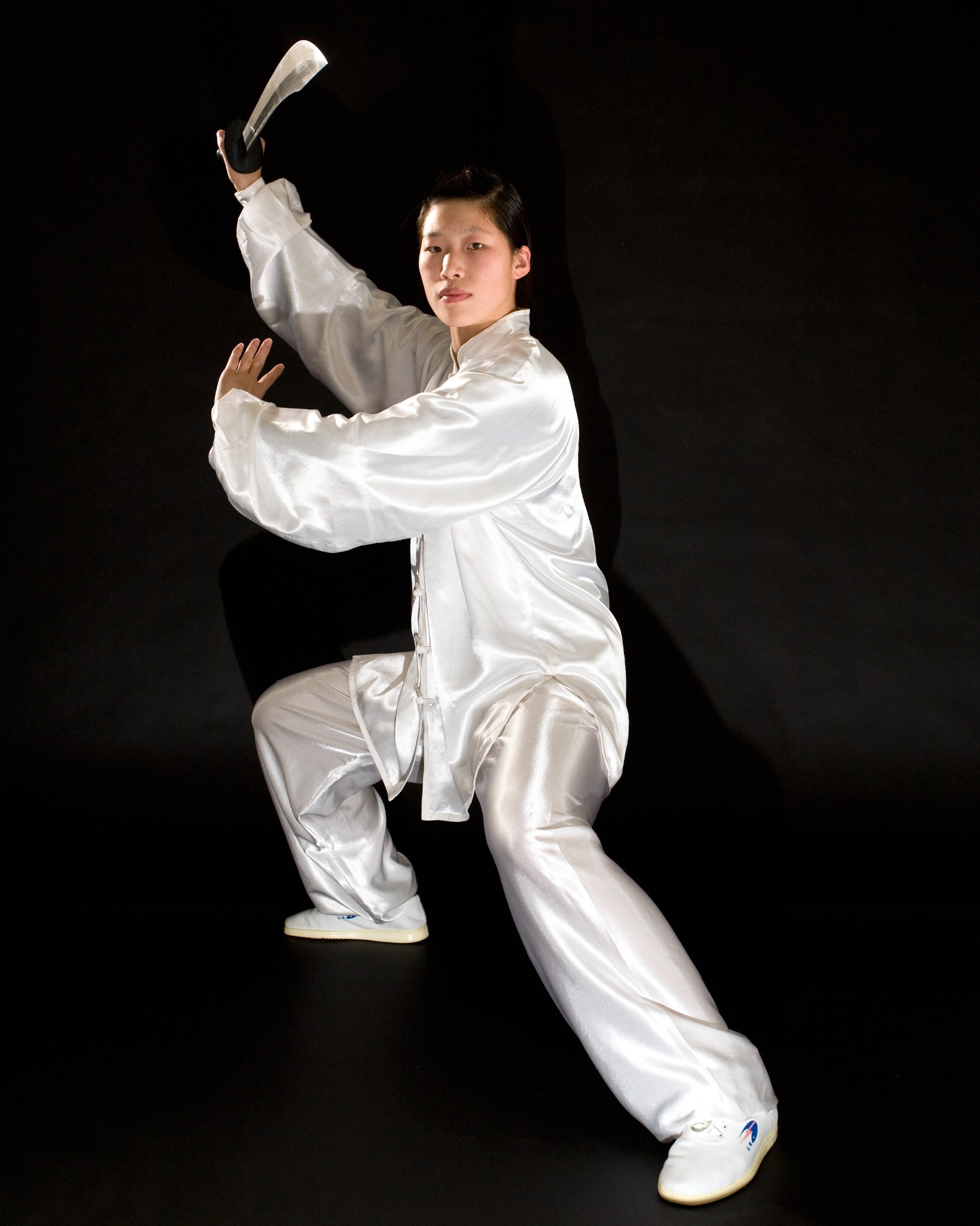 Master Chen Huixian demonstrating Chen Taiji broadsword in formal white silk