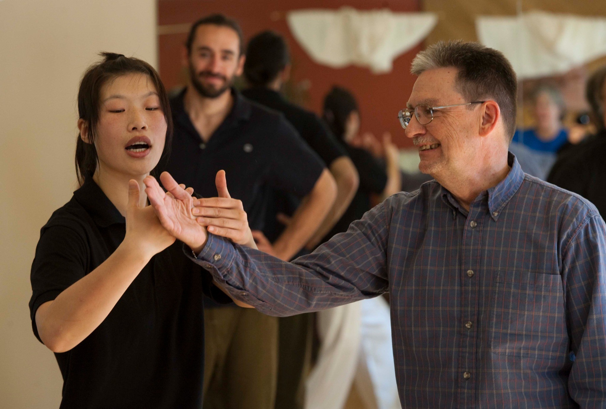 Master Chen Huixian demonstrating a posture while students follow