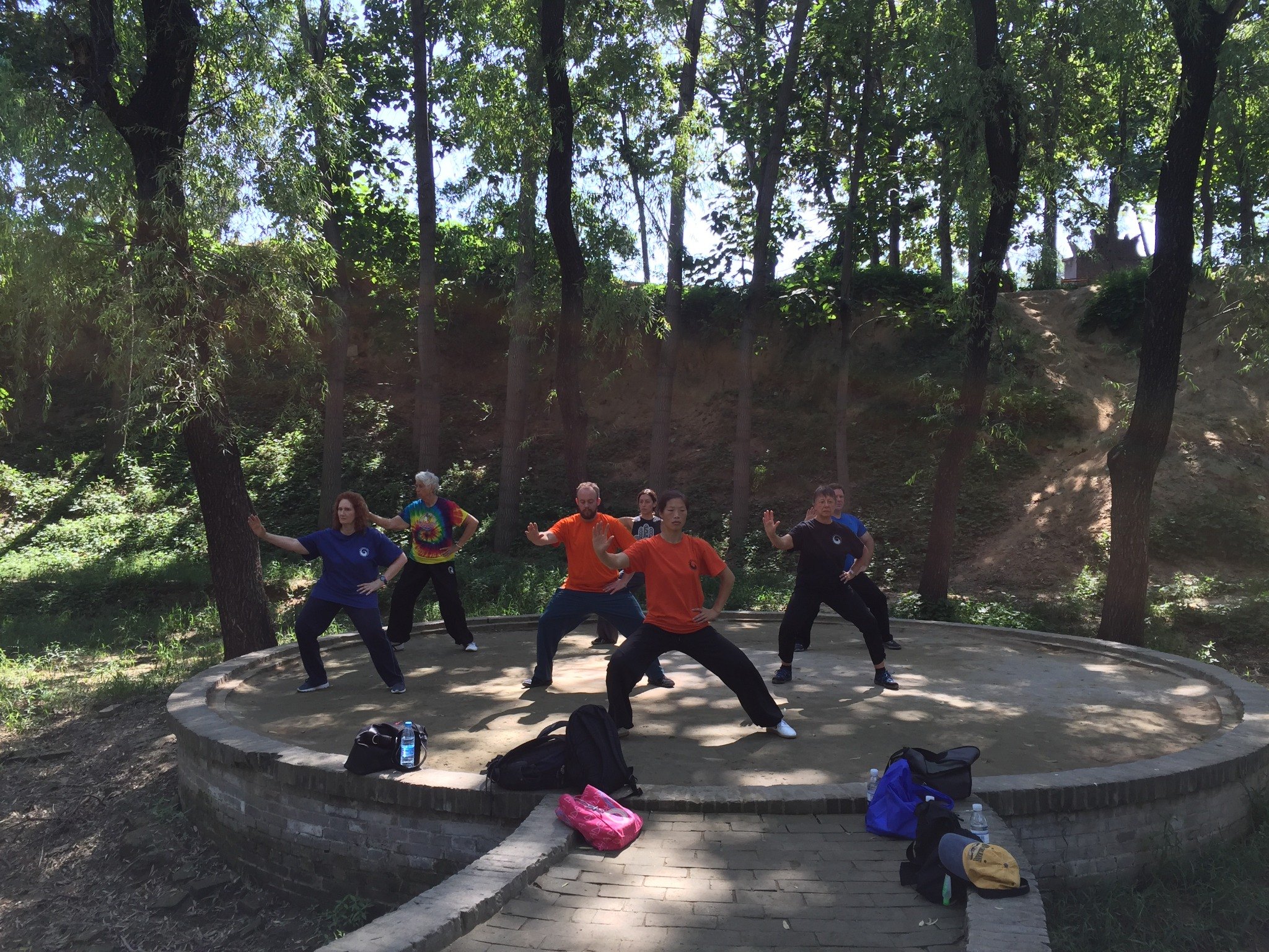 Master Chen Huixian leading an outdoor class in a wooded park